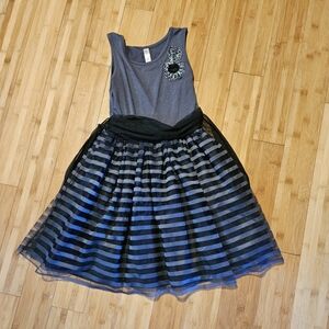Gray dress with black striped bottem and flower on top.